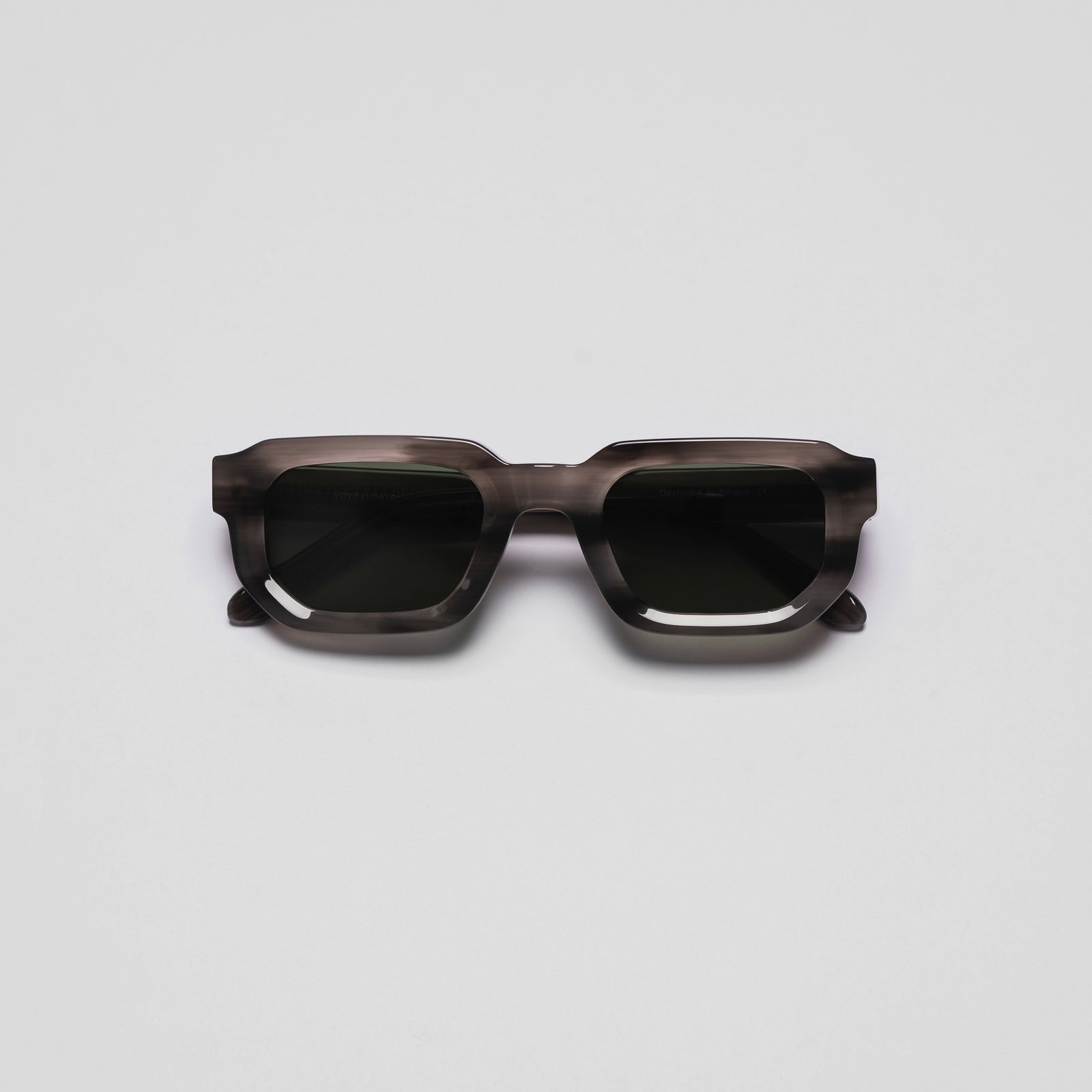 A pair of sunglasses with a space-themed design, predominantly in a dark green color.