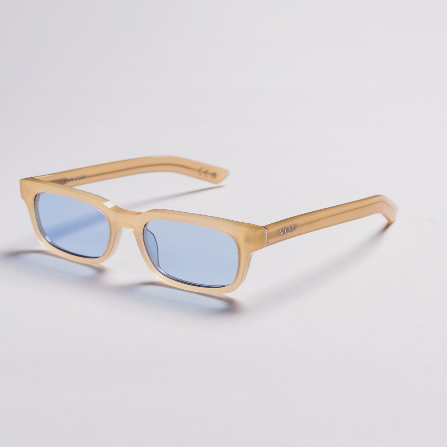 Rectangular sunglasses with a translucent light beige frame and light blue lenses, shown on a clean light gray background.