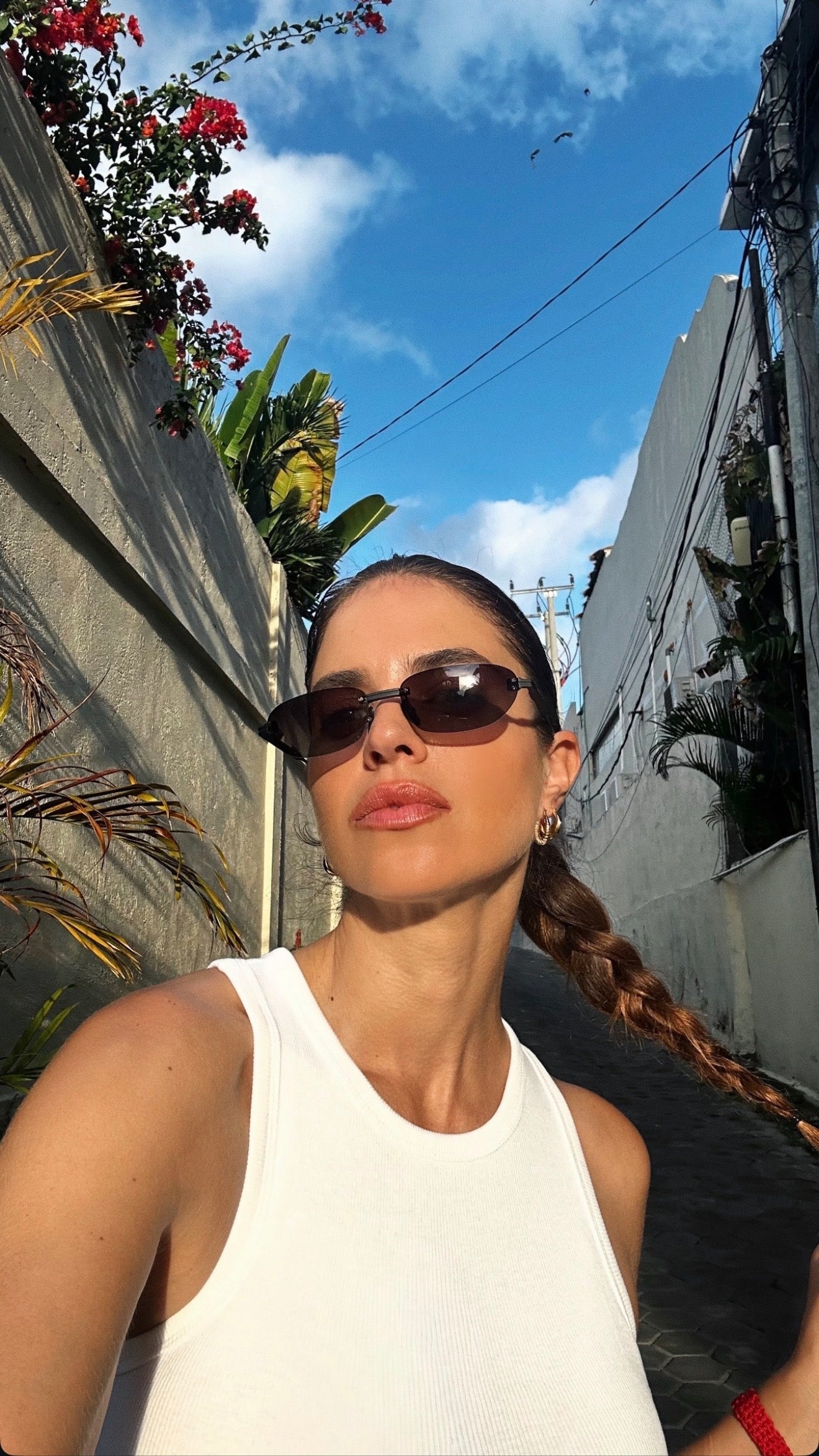 Woman wearing sunglasses with a street scene in the background