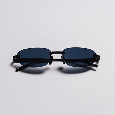 Black sunglasses with thin frame on a light gray background