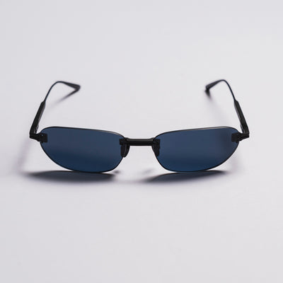Sunglasses with black frames and blue lenses on a light gray background