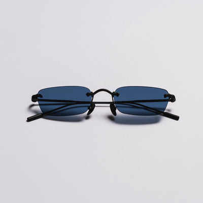 Sunglasses with black frame and blue lenses on a light gray background