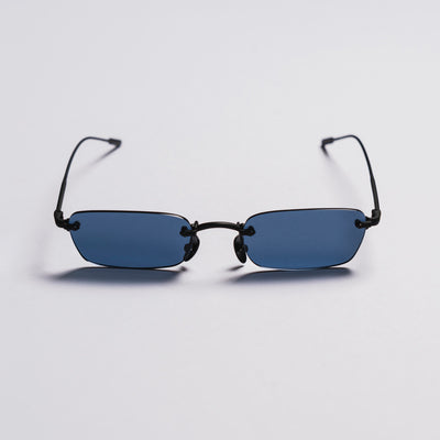 Small rectangular sunglasses with black frames and blue lenses on a light gray background