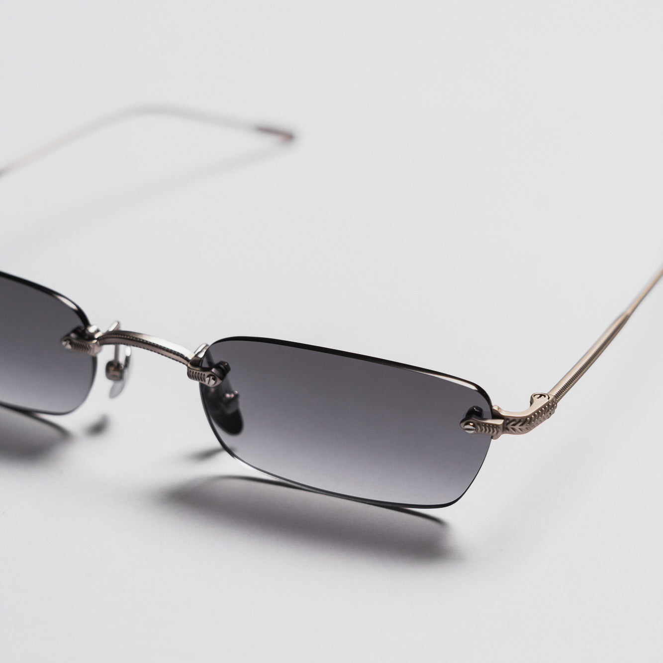 Sunglasses with gradient lenses on a light gray background