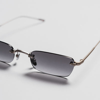 Sunglasses with gradient lenses on a light gray background