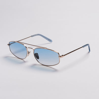 A pair of aviator-style sunglasses with light blue gradient lenses, a thin rose gold metal frame, and light blue temple tips, shown on a light gray background.