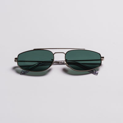 A pair of aviator-style sunglasses with dark green lenses and a thin silver metal frame, displayed on a clean light gray background.