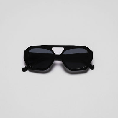A pair of black sunglasses with a geometric design on a white background