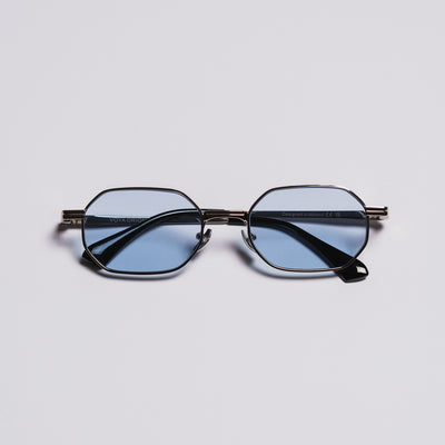 Round eyeglasses with blue-tinted lenses on a light gray background