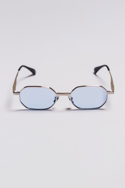 sunglasses with a silver frame and blue lenses on a light gray background